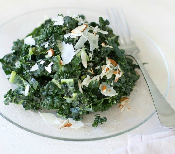 A Tuscan kale salad with parmesean cheese and almonds.